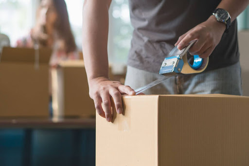 man packing a box