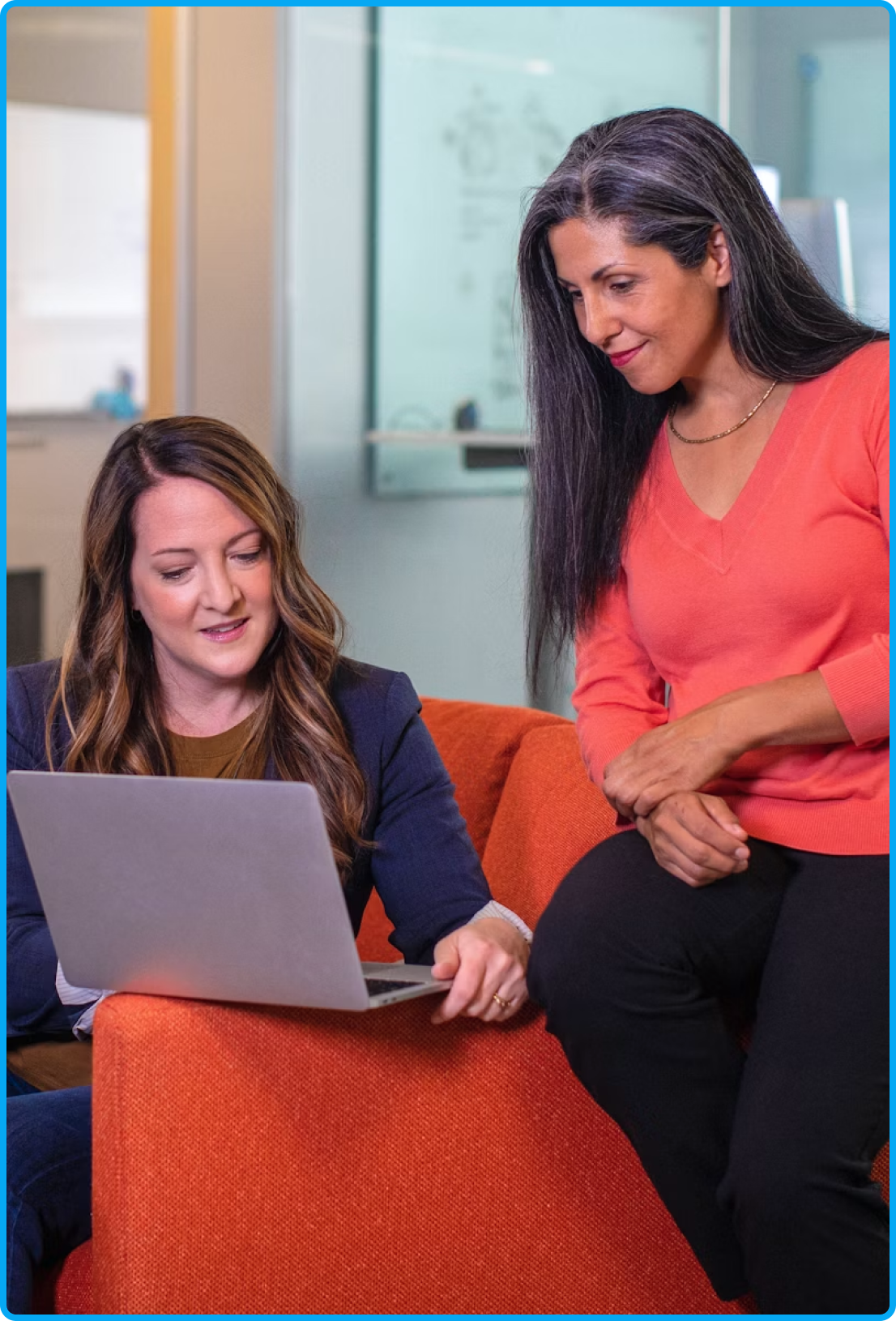 A couple of women looking with a laptop