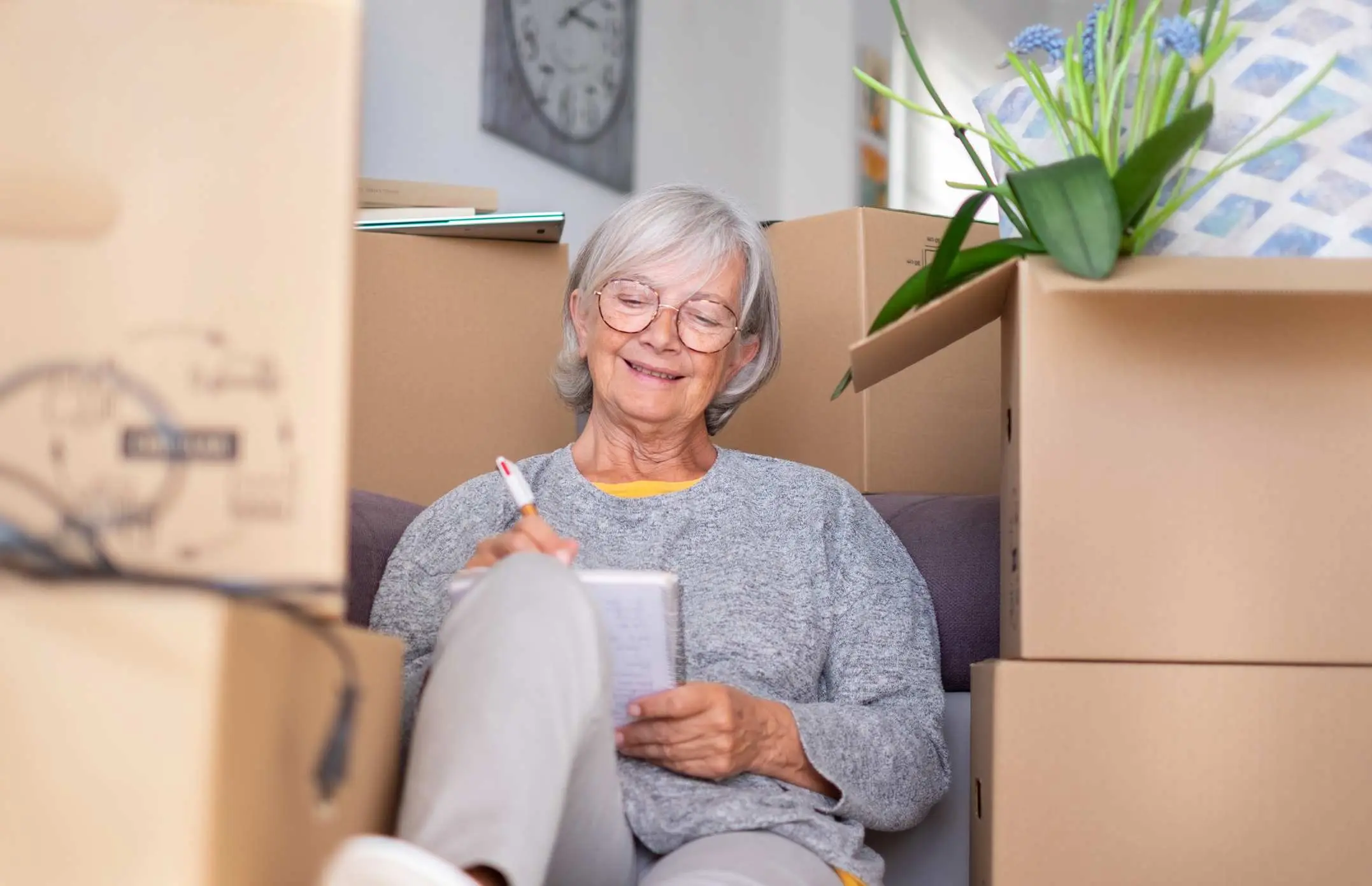 A senior woman makes a list of memories as she packs up her home.