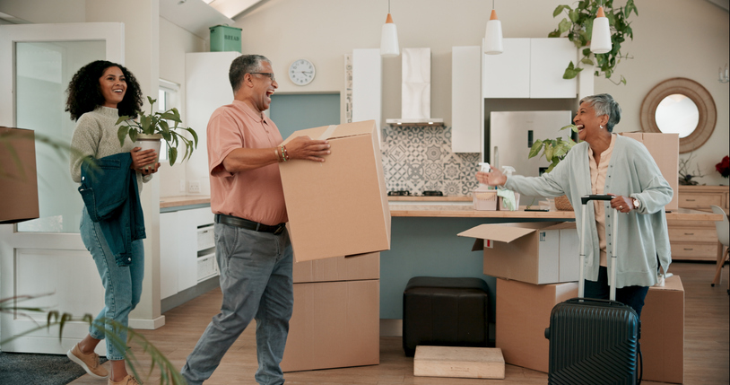 Senior parents, woman and boxes in new home for help, support or luggage with family at property. People, mother and dad with moving, suitcase or excited for investment in real estate for retirement Senior parents, woman and boxes in new home for help, support or luggage with family at property. People, mother and dad with moving, suitcase or excited for investment in real estate for retirement