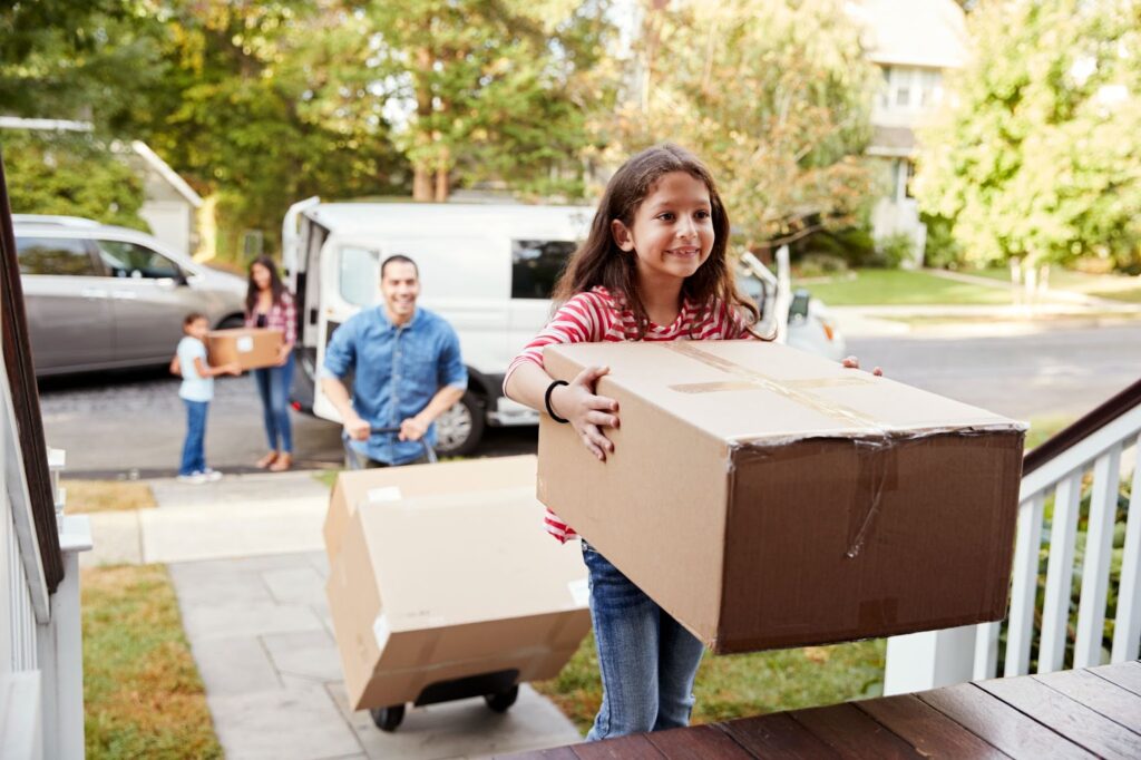 A happy family runs into their new home after a cross-country move.