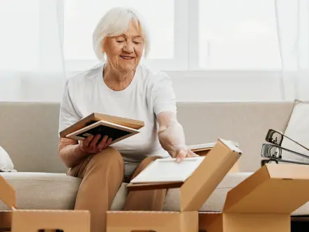 woman packing photos into boxes