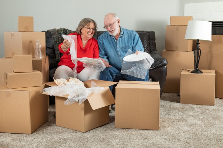 iStock-1173190085 A couple looks through cardboard storage boxes.