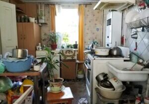 A crowded kitchen in the home of a hoarder.