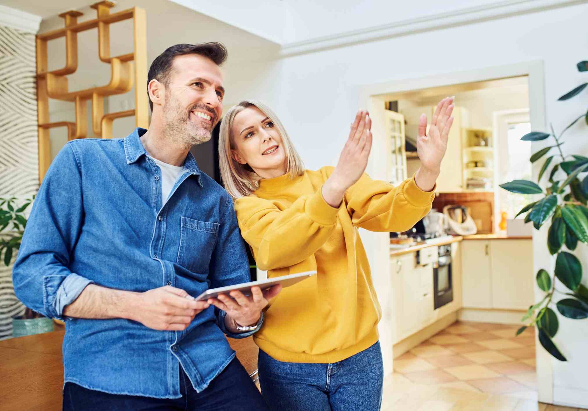 iStock-1395525239 Middle aged couple at home planning living room design