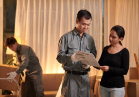 Mover asking client to sign documents, moving and delivery service concept