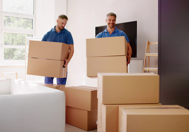 Movers Delivering Packaging Boxes. Moving And Relocation